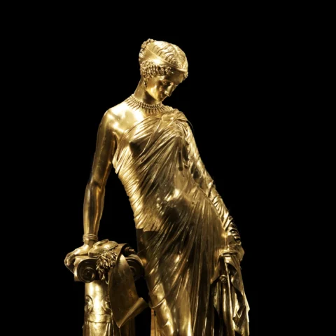 Silver statue of Sappho against a black background