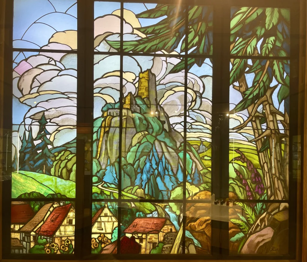Image of a stained glass with a landscape on it