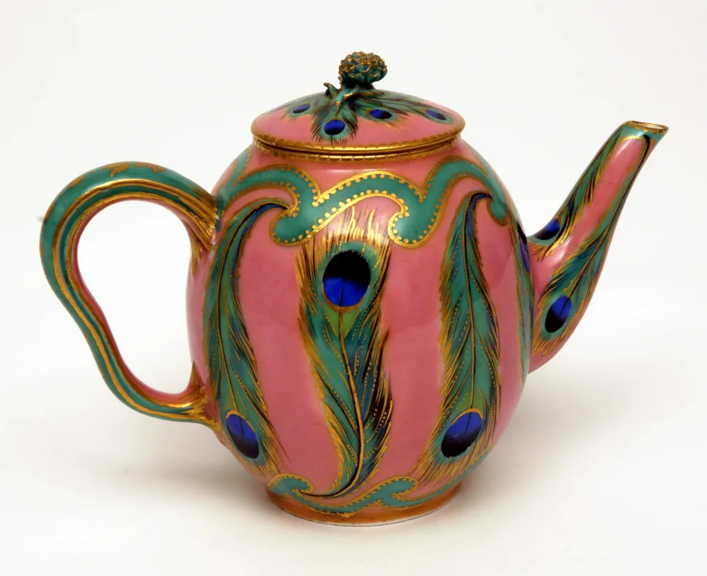 Small pink teapot with a peacock feather decoration