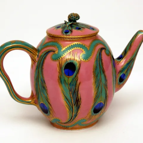 Small pink teapot with a peacock feather decoration