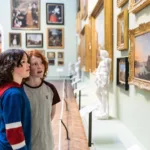 Image of young people admiring paintings in the Museum picture galleries
