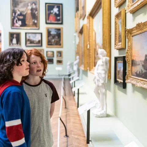 Image of young people admiring paintings in the Museum picture galleries