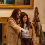 Image of a woman and child looking around the Museum galleries and pointing at an object whilst smiling.
