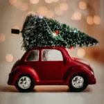 Image of a bauble in the shape of a red car with a Christmas tree on top
