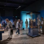 People looking at items in The Magic of the Silver Swan exhibition gallery