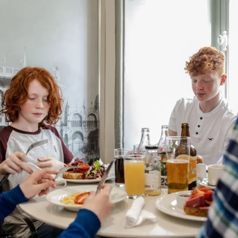 Family sitting at a table in Cafe Bowes eating