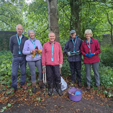 A group photograph of volunteers in The Bowes Museum's park and grounds.