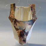 photograph of a Putti corset with images of cherubs on it on a see through mount.