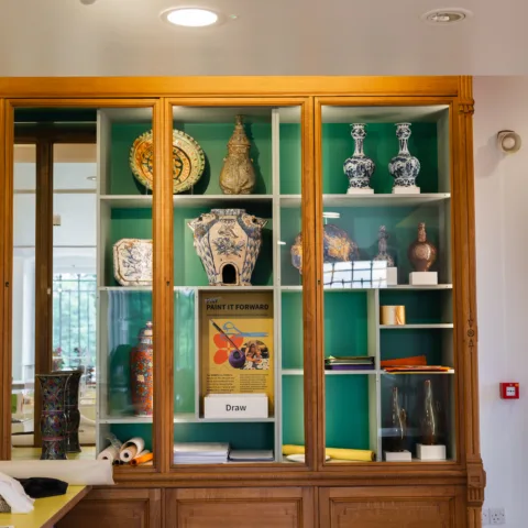 Display case in a museum filled with historic ceramic vases