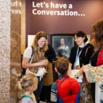 A young family talking to a member of staff.