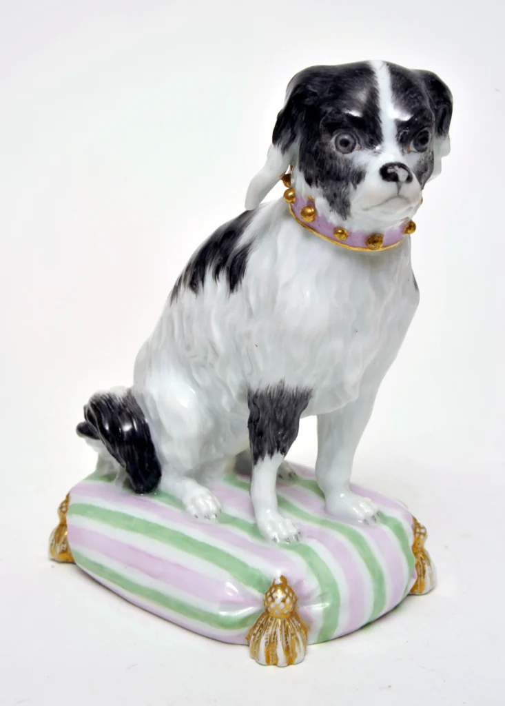 A small ceramic black and white dog