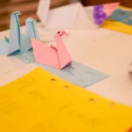 Paper swans on a white table.