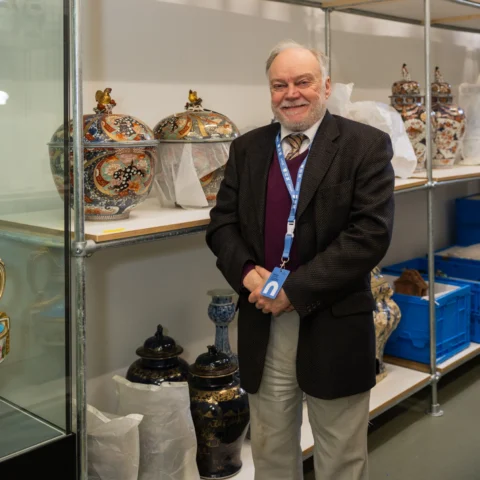 Dr Howard Coutts, standing in the ceramics vault.