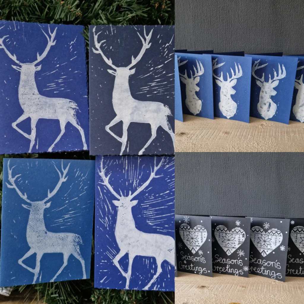 A collage of handmade greeting cards featuring block-printed designs. The top left shows two blue cards with white reindeer silhouettes surrounded by radiating lines. The top right displays a row of similar reindeer cards in varying shades of blue. The bottom right includes black cards with white heart motifs and the text “Season’s Greetings” in a handwritten style.