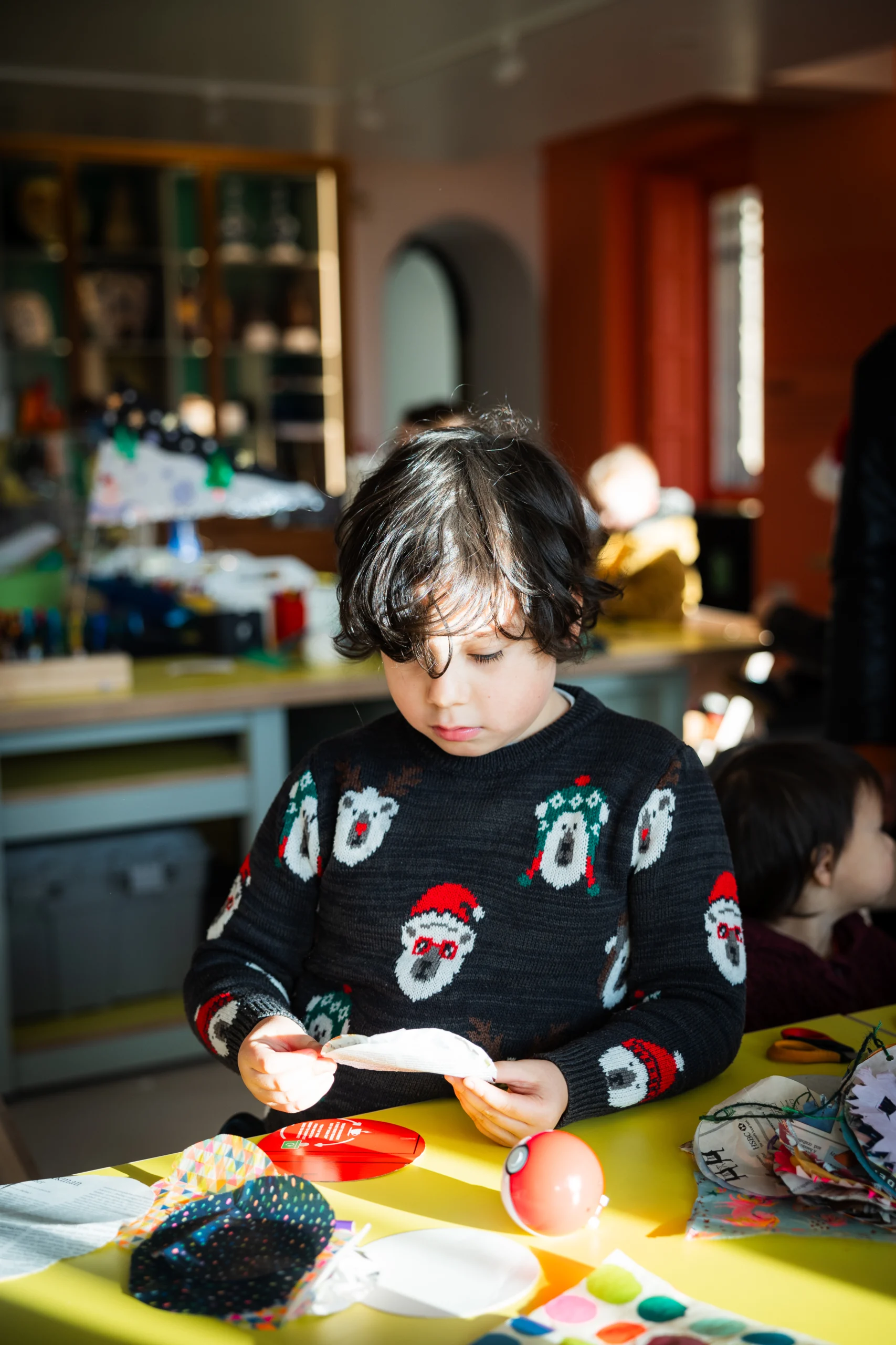 A young boy making art in the create space