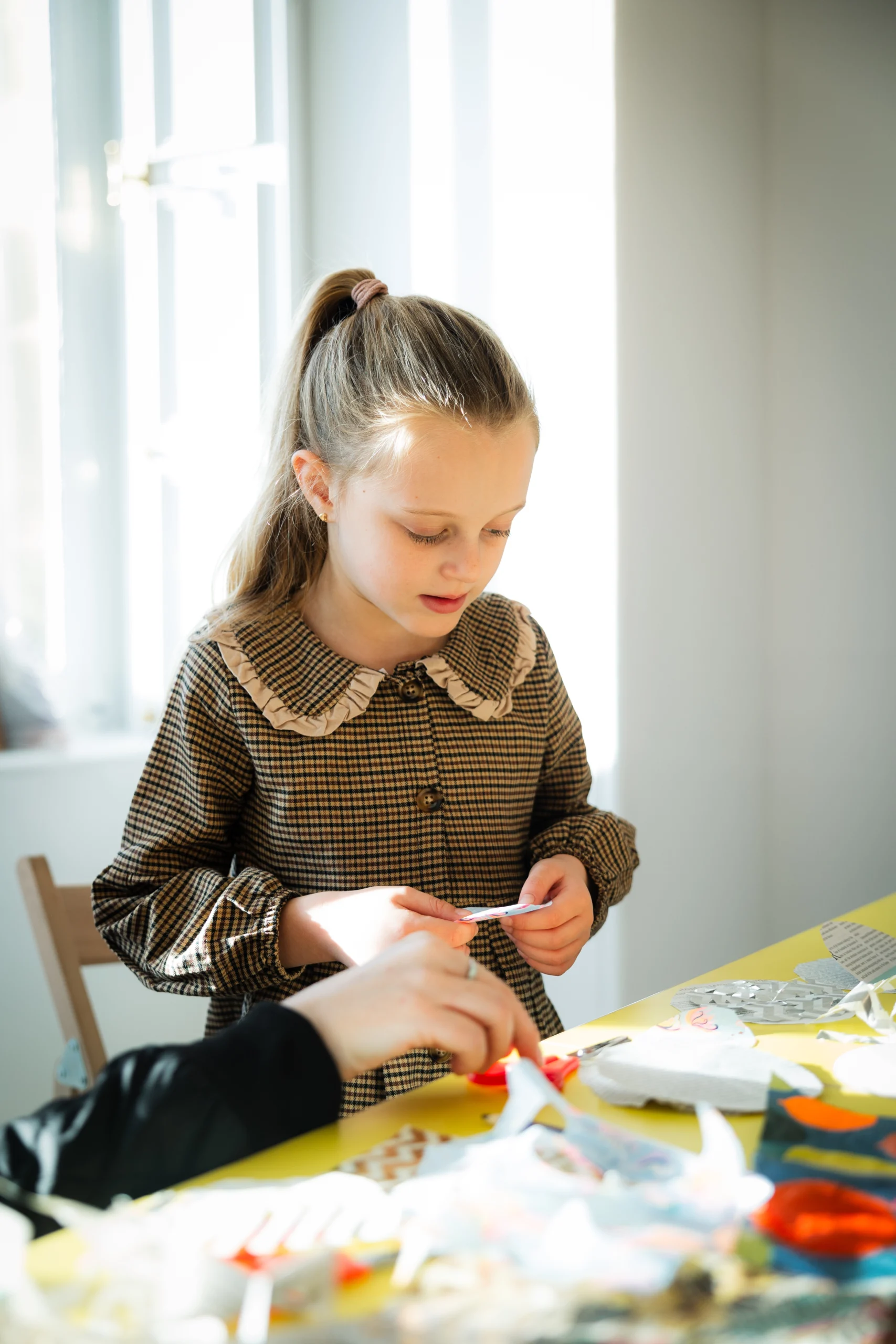 A young girl making art in a bright gallery space