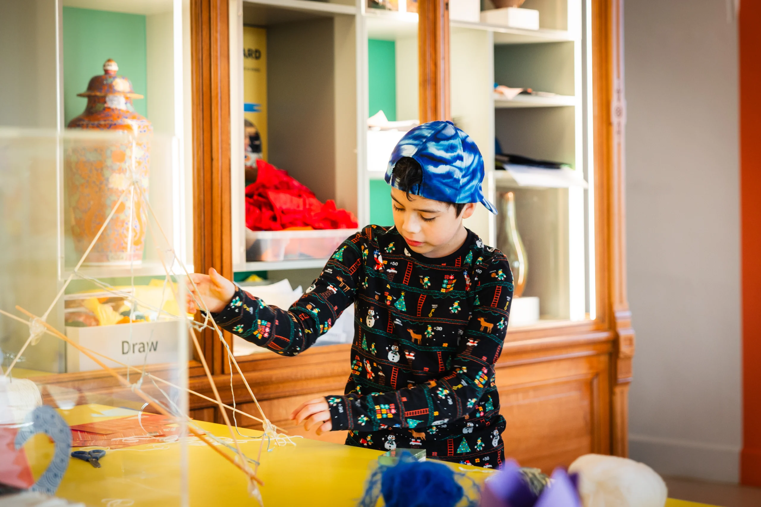 A young boy making art in the create space