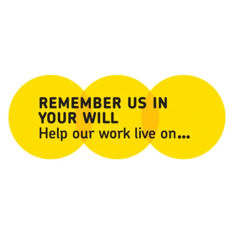 raphic design featuring three overlapping bright yellow circles on a white background. The central circle contains bold black text reading “REMEMBER US IN YOUR WILL” and smaller text below stating “Help our work live on…”. The design uses a clean, modern font and a simple layout to convey a charitable message.