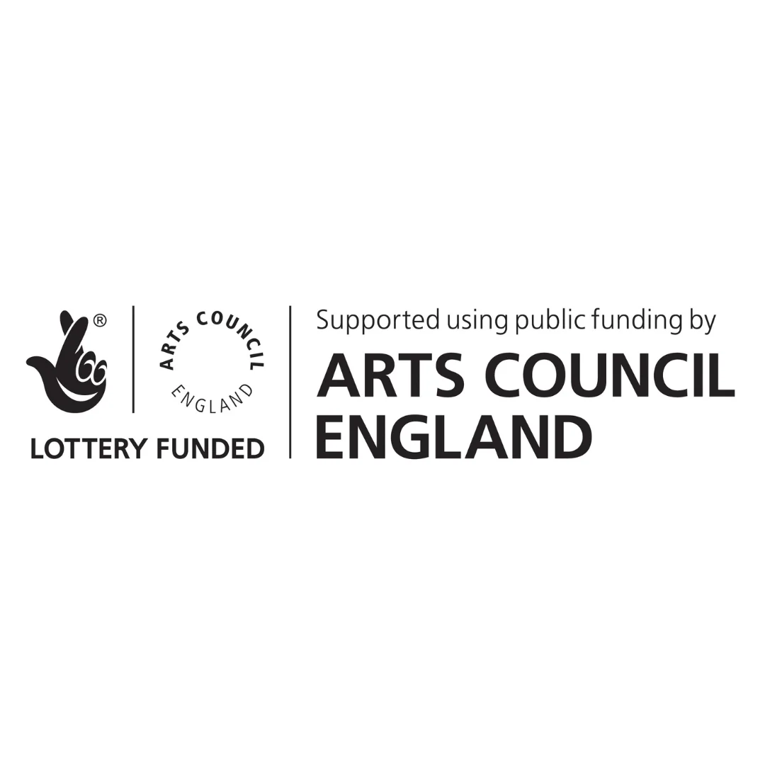 Black‑and‑white logo featuring the National Lottery hand symbol alongside the words “Lottery Funded” and the circular “Arts Council England” emblem. To the right, the text reads: “Supported using public funding by Arts Council England.”