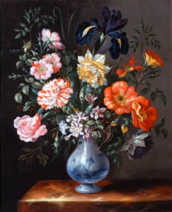 A painted still life shows a large bouquet of flowers arranged in a blue‑and‑white ceramic vase, set on a wooden tabletop. The bouquet includes roses, poppies, irises, carnations, and small daisy‑like flowers in shades of pink, red, orange, yellow, white, and deep blue, with green leaves and stems spreading outward. The background is dark and plain, creating contrast with the brightly coloured flowers and the reflective surface of the vase.